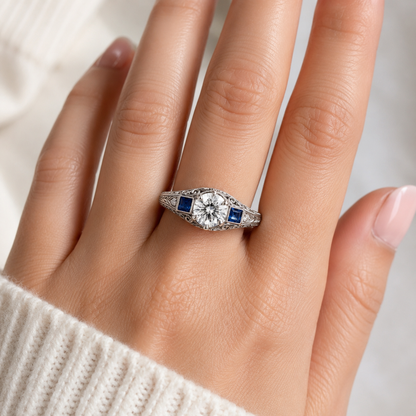 VINTAGE ROUND DIAMOND AND BLUE SAPPHIRE THREE STONE ENGAGEMENT RING